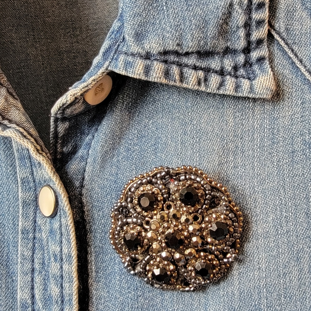 Silver and black pin/broach. 2 inches.